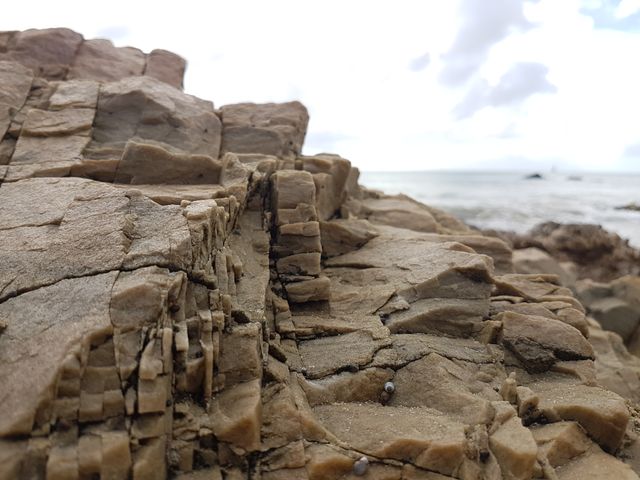 Ideal for backgrounds, nature-focused blogs, or educational materials on geology and coastal environments. Use it to emphasize themes of natural beauty, rugged terrains, or weathered landscapes influenced by sea and wind.