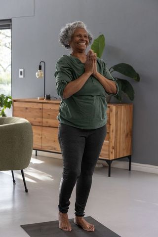 Senior Woman Practicing Yoga at Home for Mindfulness and Wellness