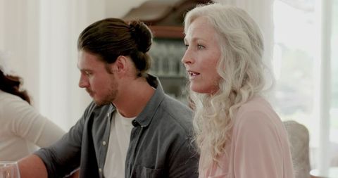 Guests enjoying lively wedding reception with wine