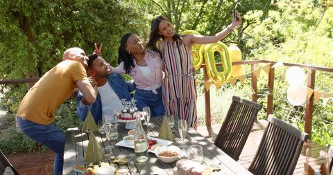 Friends Celebrating Outdoors with Birthday Selfies