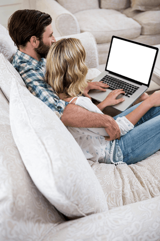 Couple Relaxing at Home Browsing Laptop Isolated Screen