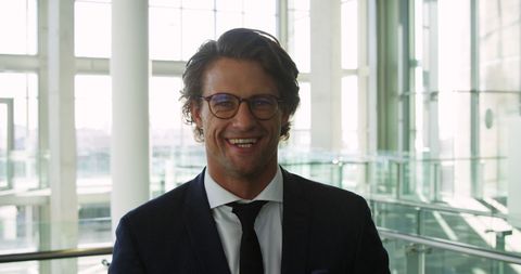 Confident Businessman Smiling in Contemporary Office