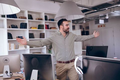 Professional Man Leading Meeting in Modern Office Space