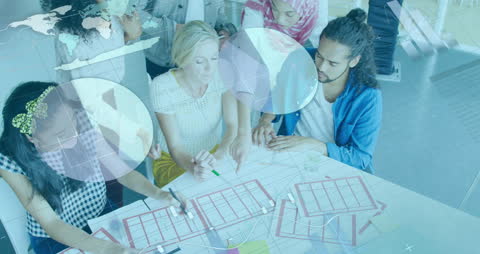 Diverse Coworkers Collaborating on Blueprint and Data Analysis