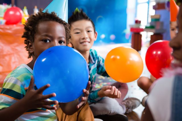 Children enjoying a party, playing with colorful balloons. Perfect for use in advertisements, party planning materials, children's event promotions, and educational content about social activities and celebrations.