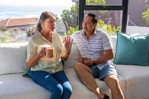 Senior Couple Enjoying Coffee in Sunlit Coastal Living Room