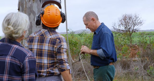 Mature Workers Collaborating in Outdoor Farming Environment - Download Free Stock Images Pikwizard.com