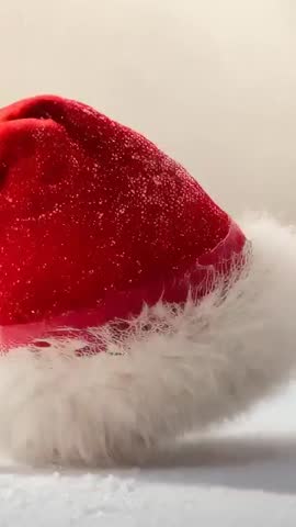 Swaying Santa Hat Settling on Snow, Flakes Dusting Fur Cuff | Velvet Holiday Vertical Loop