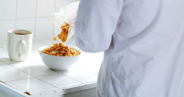 Preparing Breakfast with Cereal and Coffee in White Kitchen - Download Free Stock Images Pikwizard.com