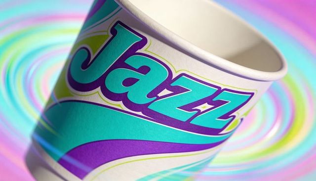 Displaying retro jazz-branded paper cup with teal purple swirls on pastel concentric backdrop