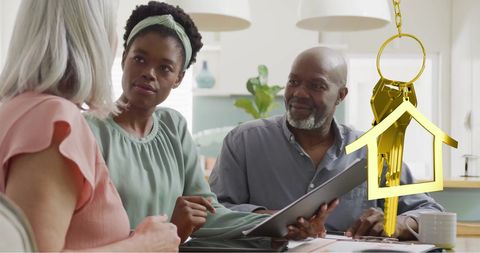 Diverse couple meeting with financial advisor in home kitchen