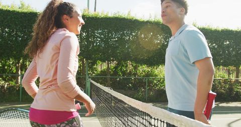 Happy Couple Enjoying Tennis Match on Sunny Day