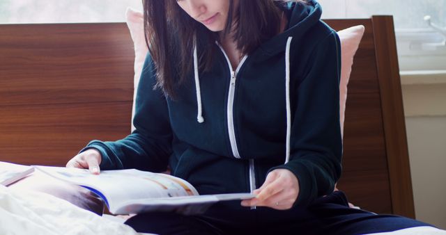 Young Woman Reading Book on Bed in Cozy Interior - Download Free Stock Images Pikwizard.com