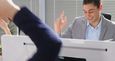 Young Businessmen Celebrating Successful Deal with High-Five