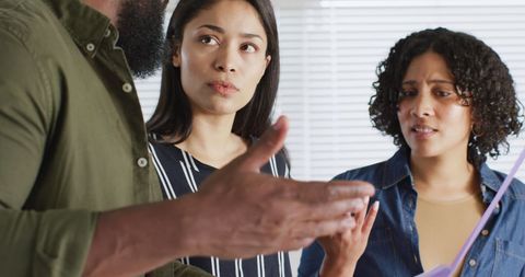 Diverse team discussing project in home office