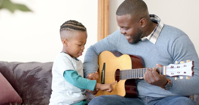 Father Teaching Son to Play Guitar at Home - Download Free Stock Images Pikwizard.com