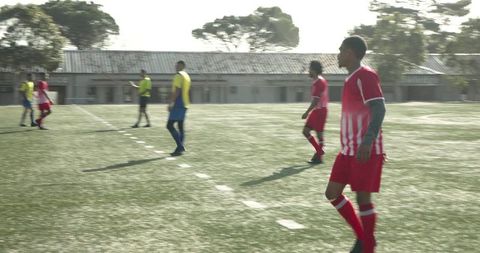 Teen Soccer Players Practicing on School Field for Match