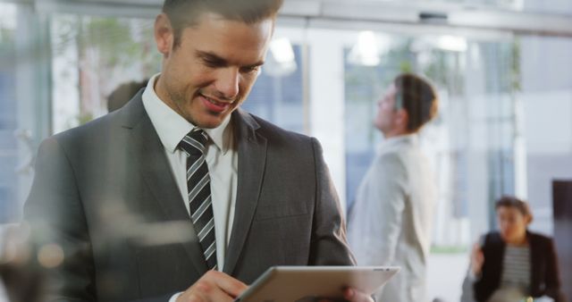 Businessman Using Digital Tablet in Modern Office Setting - Download Free Stock Images Pikwizard.com