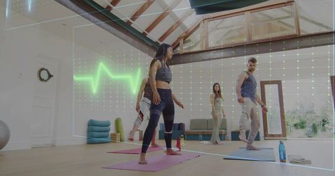 Group practicing balance lunges with ecg biofeedback overlay in bright loft yoga studio