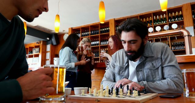 Friends Enjoying Drinks and Playing Chess in Cozy Cafe - Download Free Stock Images Pikwizard.com