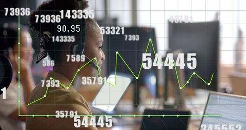 Businesswoman Analyzing Financial Data on Multiple Devices in Office