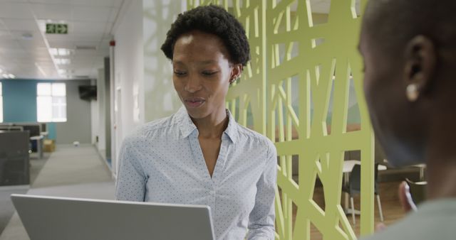 Businesswoman Discussing Project on Laptop in Office Environment - Download Free Stock Images Pikwizard.com