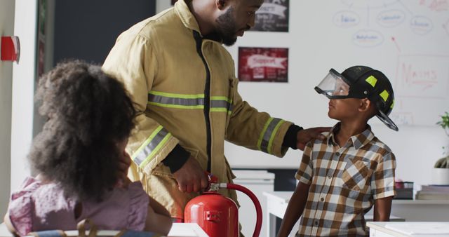 Firefighter teaching fire safety to children in a classroom, engaging them with hands-on demonstrations including the use of a fire extinguisher and wearing safety gear like helmets. Useful for educational content, safety training materials, community outreach programs, and promotional materials for emergency services.