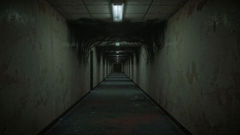 Eerie abandoned corridor with peeling paint and hanging cables