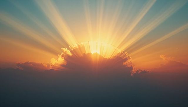 Radiant Sunbeams Emerge Through Dawn Sky at Sunrise