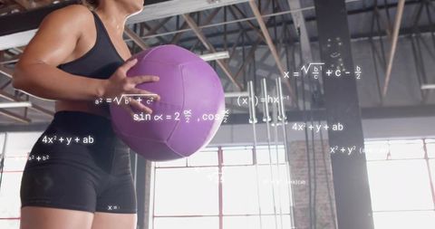Female athlete holding purple medicine ball training with equations overlay