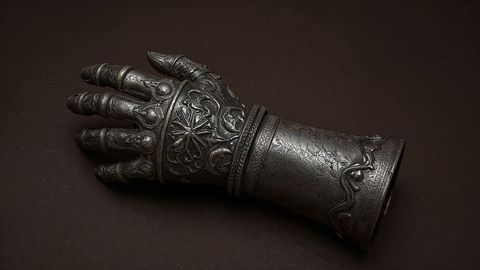 Intricately-engraved medieval gauntlet with carved patterns