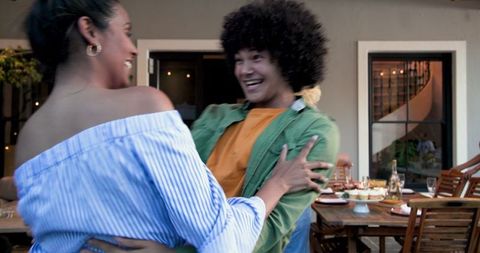 Happy friends celebrating engagement dinner party outdoors