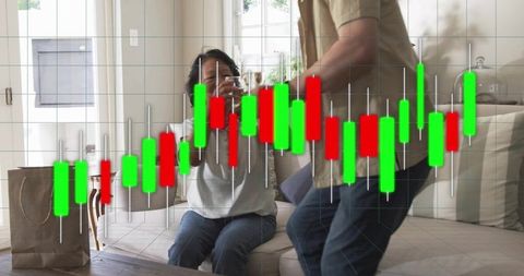 Senior woman receiving glass from partner at home while candlestick stock chart overlaying