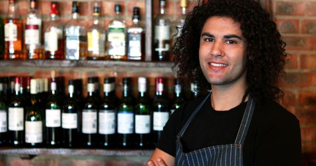 Confident Bartender Standing in Bar with Shelves of Bottles - Download Free Stock Images Pikwizard.com