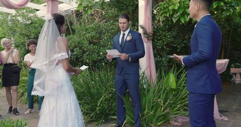 Bride and groom exchanging vows at outdoor wedding ceremony