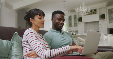 Cheerful Couple Engaged with Laptop on Couch - Download Free Stock Images Pikwizard.com