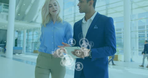 Diverse Business Professionals Using Tablet with Networking Icons Overlay