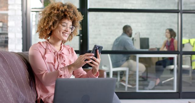 Businesswoman Using Smartphone and Laptop in Office Lounge Area - Download Free Stock Images Pikwizard.com