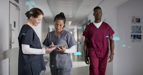 Healthcare Professionals Analyzing Data in Busy Hospital Corridor - Download Free Stock Images Pikwizard.com