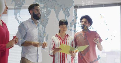Multicultural team collaborating over global strategy with digital map overlay