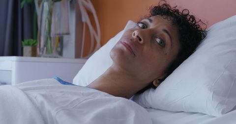 Worried Woman Resting in Hospital Bed