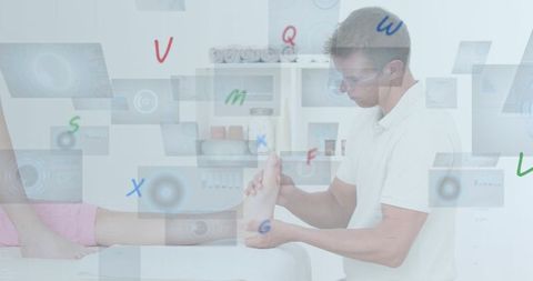 Male Physiotherapist Analyzing Digital Data on Patient's Foot