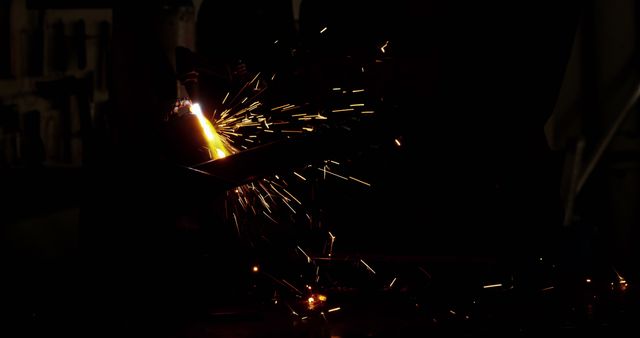 Welder Creating Sparks in Dark Workshop - Download Free Stock Photos Pikwizard.com