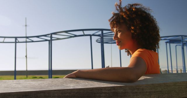 Thoughtful Young Woman Relaxing at Playground in Sunlight - Download Free Stock Images Pikwizard.com