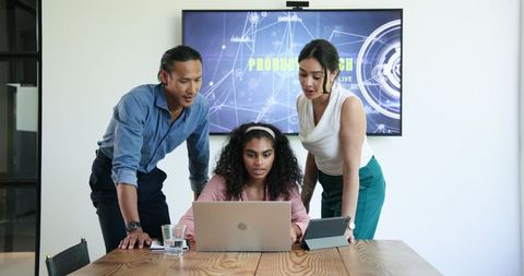 Diverse Team Engaged in Dynamic Office Work Discussion