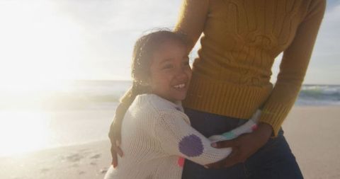 Joyful Daughter Embracing Mother On Beach At Sunset