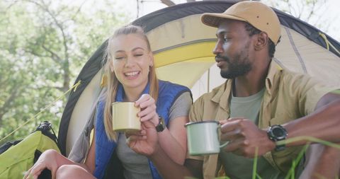 Happy Couple Enjoying Tea at Camp in Sunny Park