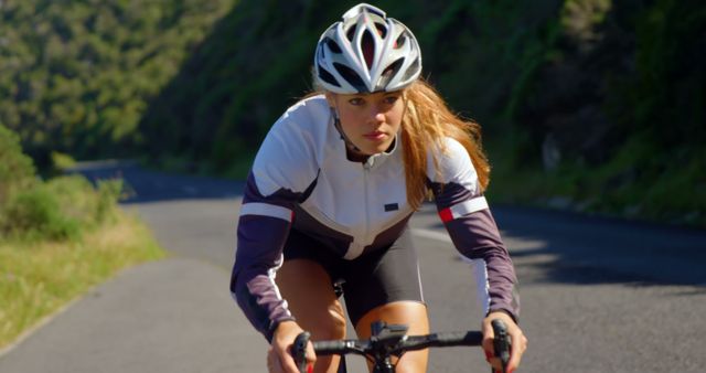 Focused Woman Cycling on Mountain Road - Download Free Stock Images Pikwizard.com