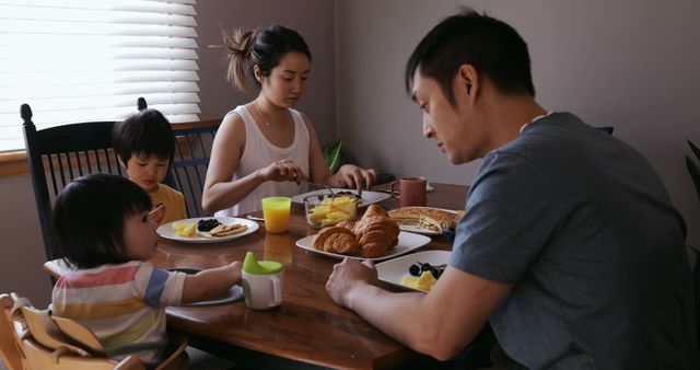 Asian Family Having Breakfast Together Around Dining Table - Download Free Stock Images Pikwizard.com