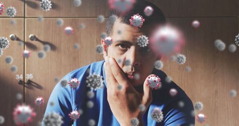 Soccer Player Surrounded by Covid-19 Cells in Locker Room